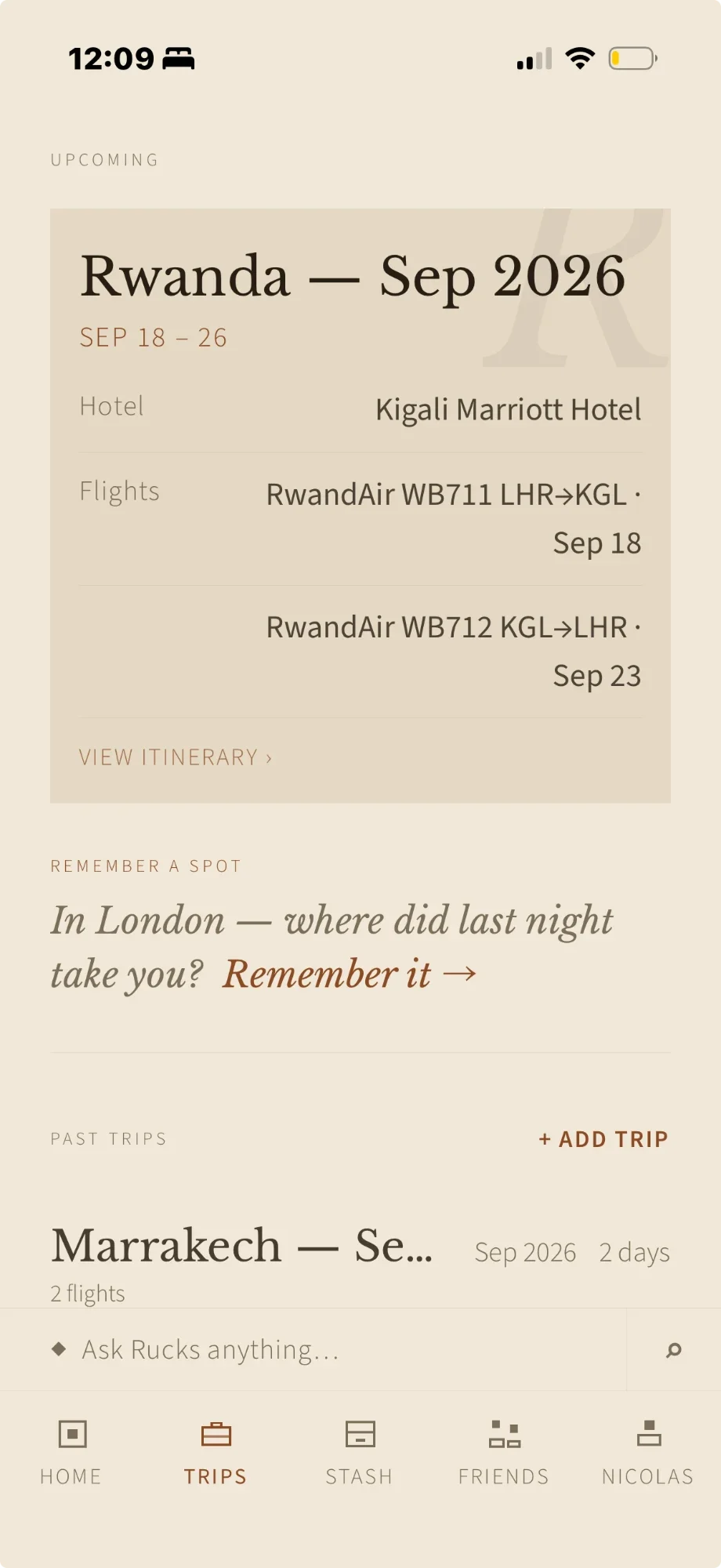 The Trips screen in Rucks: an upcoming trip to Rwanda with its hotel and flights, a prompt to remember last night's spot in London, and past trips below